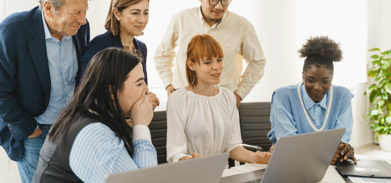 Creative Team Reviewing Project on Laptop
