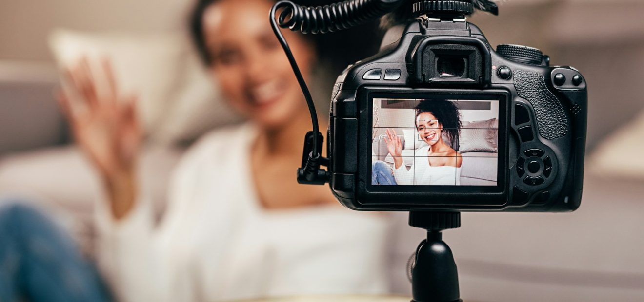 Vlogger recording content for her blog on a DSLR camera